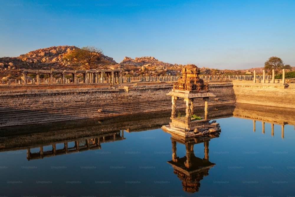 Temple and water tank at Hampi, the centre of the Hindu Vijayanagara Empire in Karnataka state in India