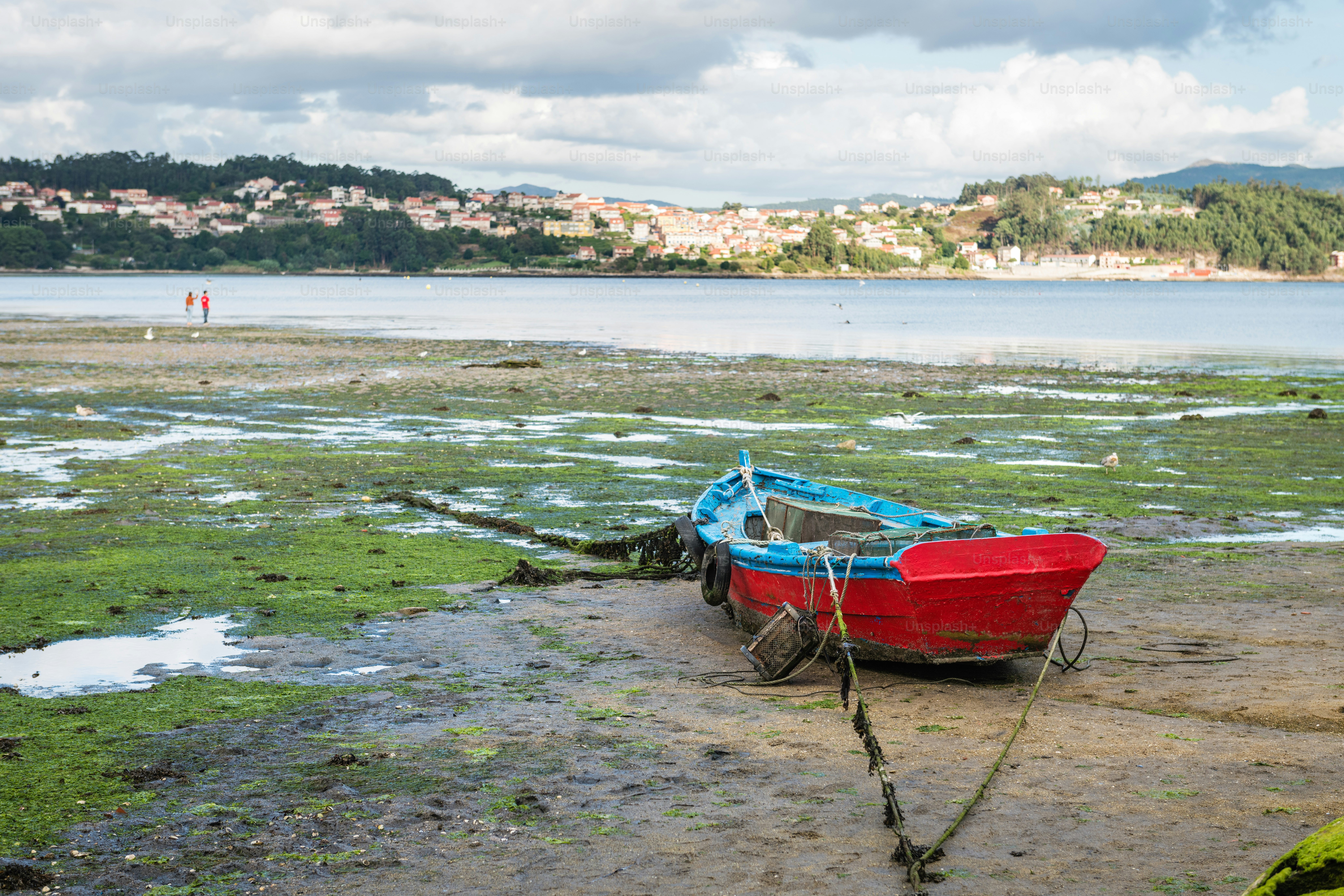 Lonely wooden boat stranded during low tide at the well-preserved village of Combarro in Ponteveda, Spain.