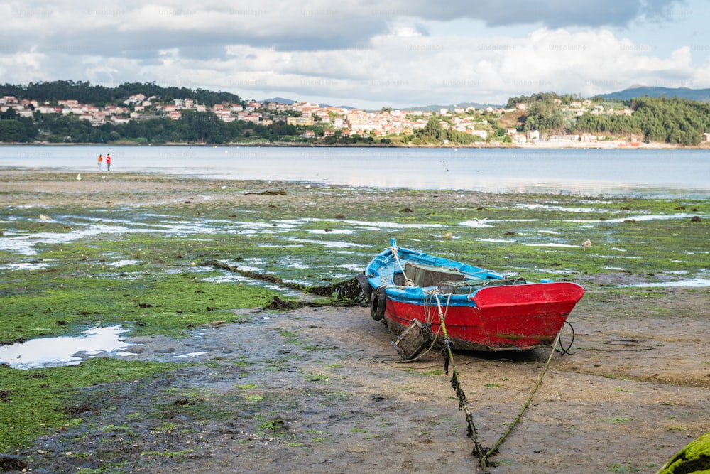 Lonely wooden boat stranded during low tide at the well-preserved village of Combarro in Ponteveda, Spain.