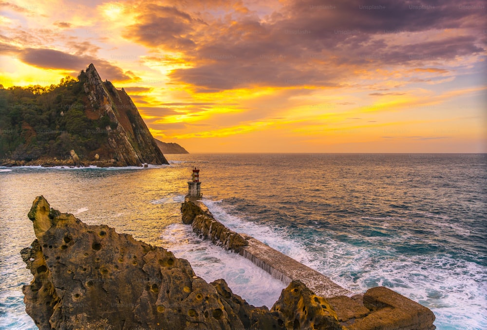 Sunset at the lighthouse in the municipality of Pasajes San Juan in Gipuzkoa. Basque Country