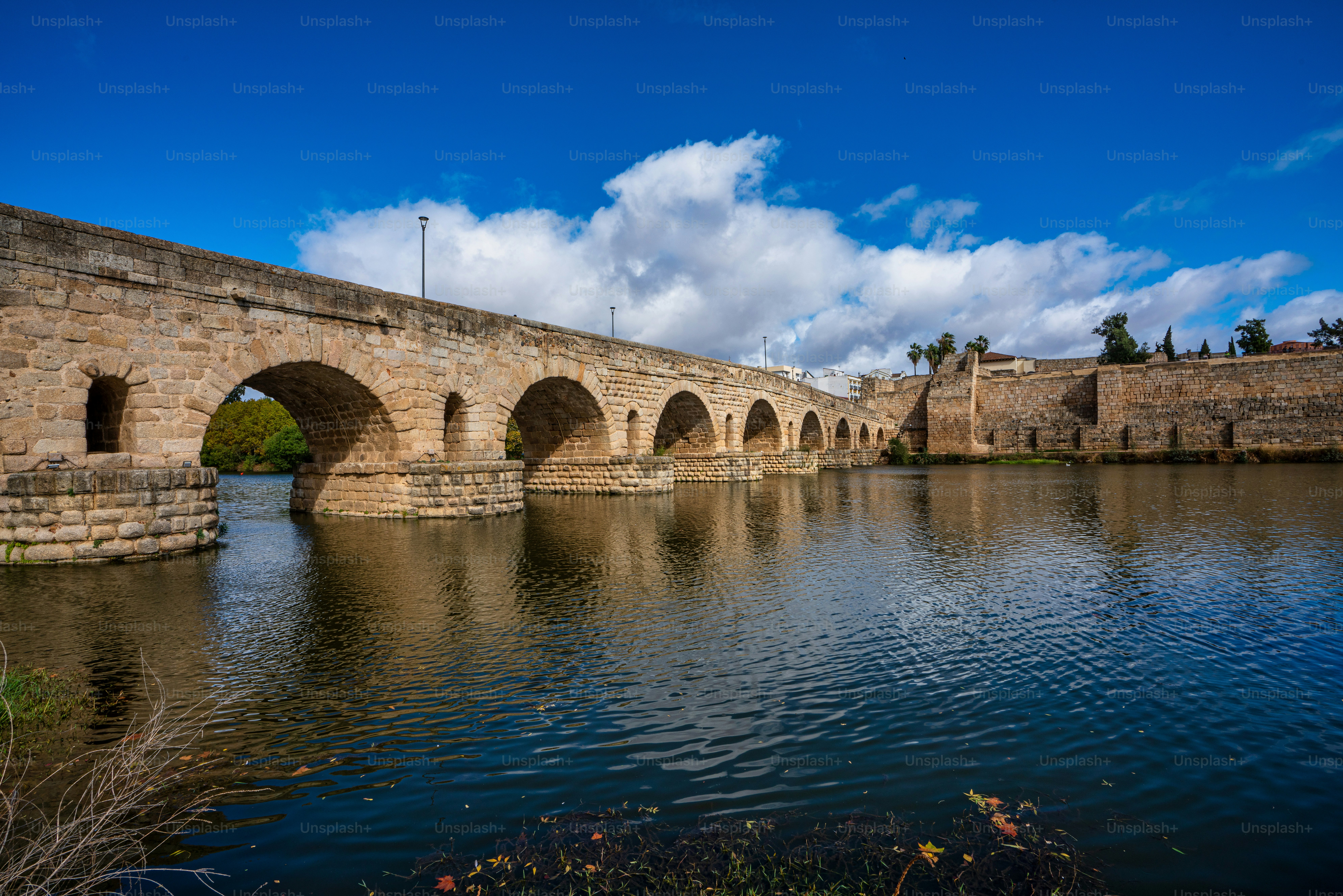 Puente Romano, die römische Brücke in Mérida, Extremadura, Spanien. Es ist die längste erhaltene römische Brücke über den Fluss Guadiana in Mérida. Im Hintergrund sehen wir die Alcazaba.