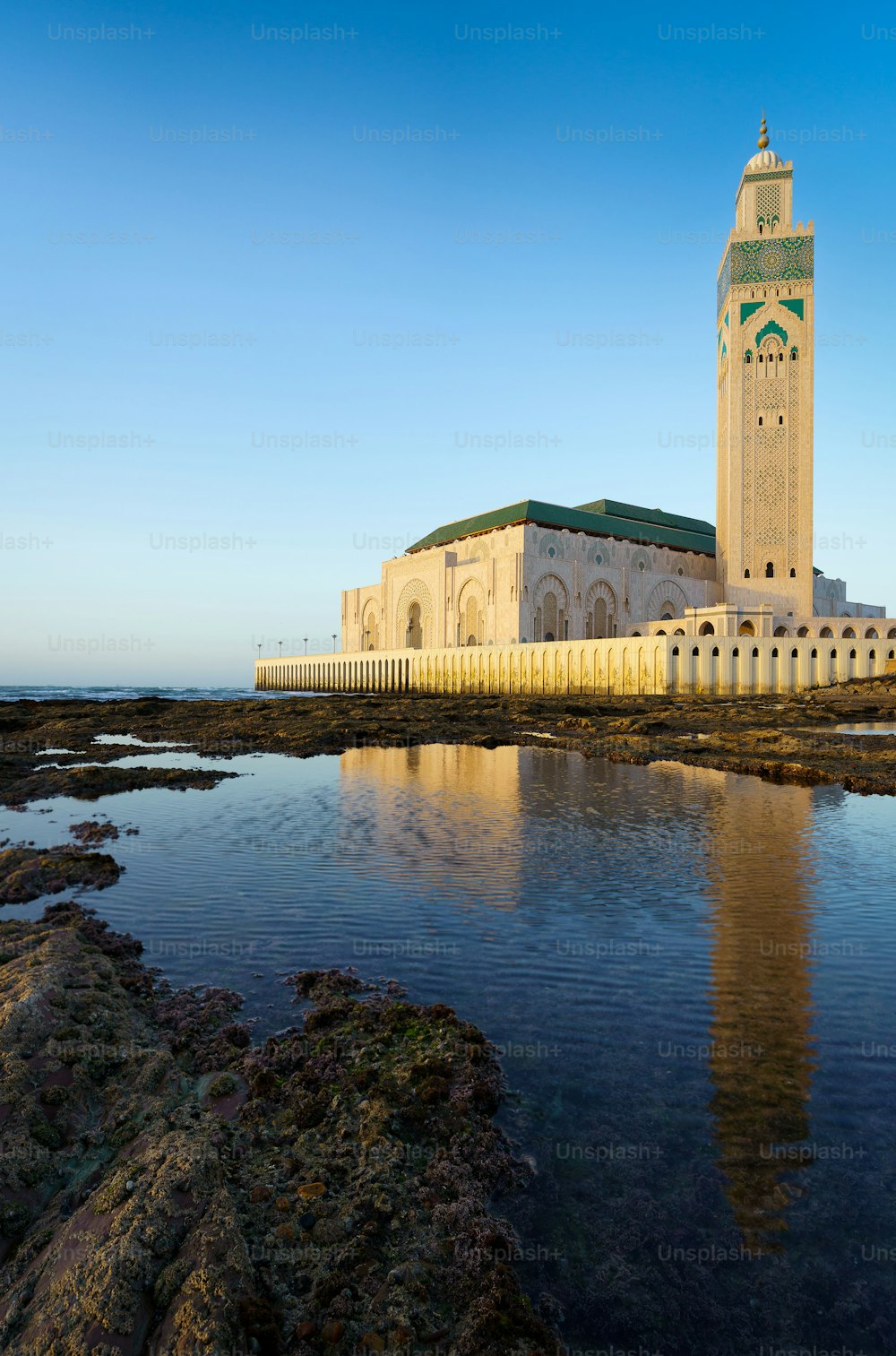 The beautiful Hassan II Mosque with its reflection on the water in Casablanca, Morocco