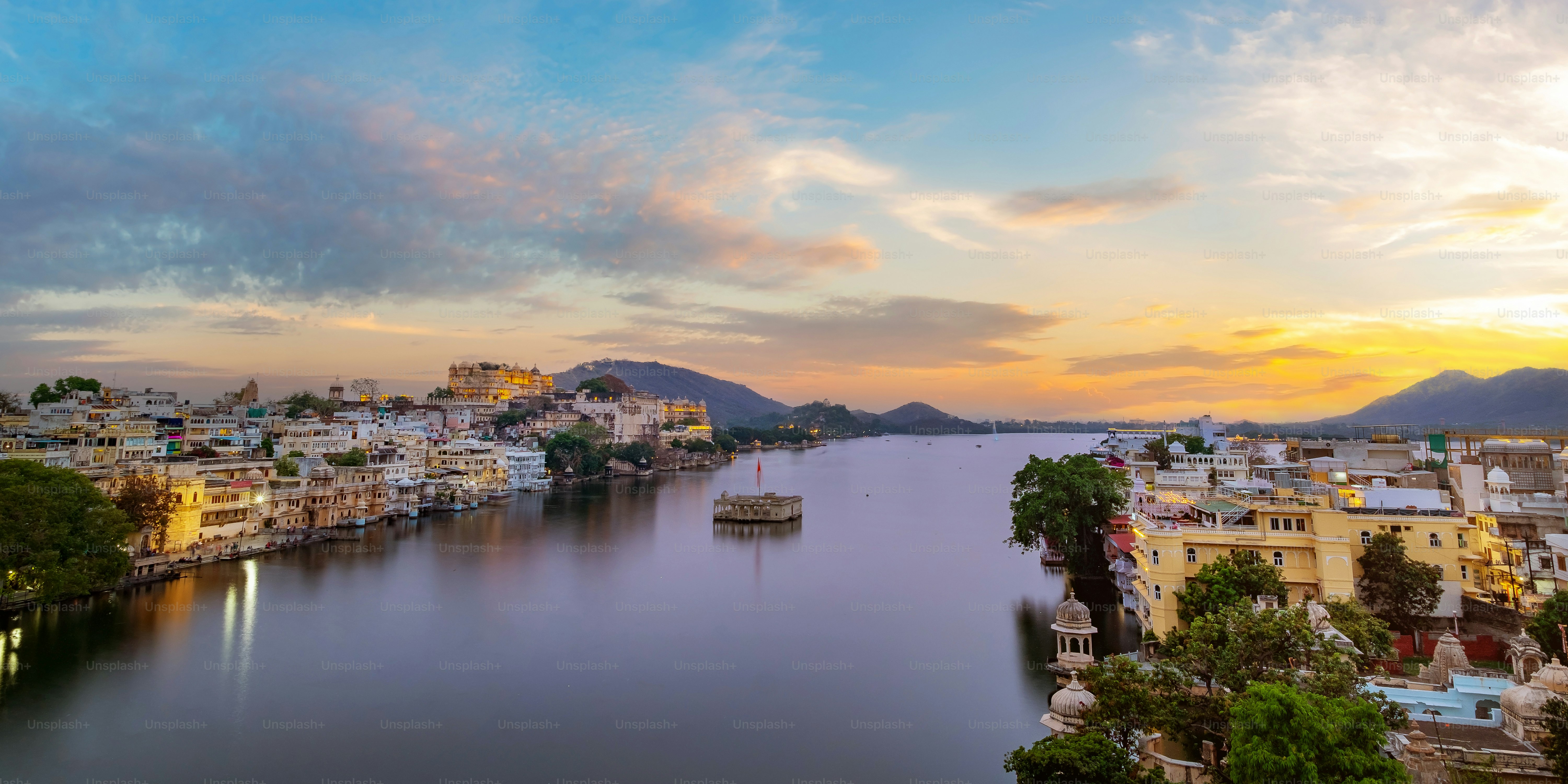 Udaipur city at lake Pichola in the evening, Rajasthan, India. View of City palace reflected on the lake.