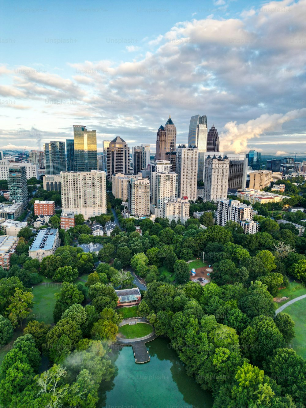 A vertical drone view of the Downtown Atlanta with modern buildings and a large green park, Georgia