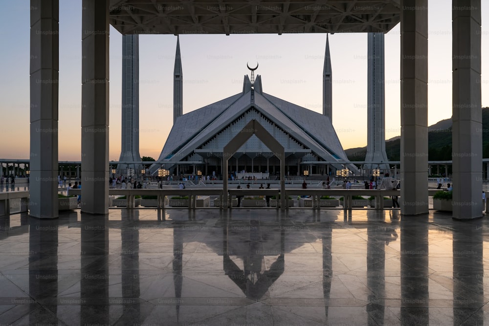 a beautiful shot of the Shah Faisal Masjid Mosque in Islamabad, Pakistan at sunset