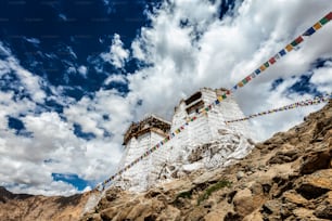 Ruins of Victory Fort Tsemo on the cliff of Namgyal hill and colorful Buddhist prayer flags with Buddhism mantra written on them. Leh, Ladakh, Jammu and Kashmir, India