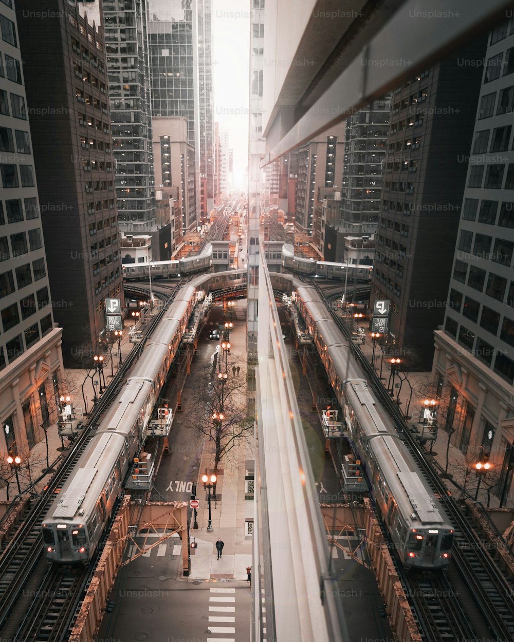 A vertical shot of a train symmetrically mirrored in the glass office building in Chicago, Illinois