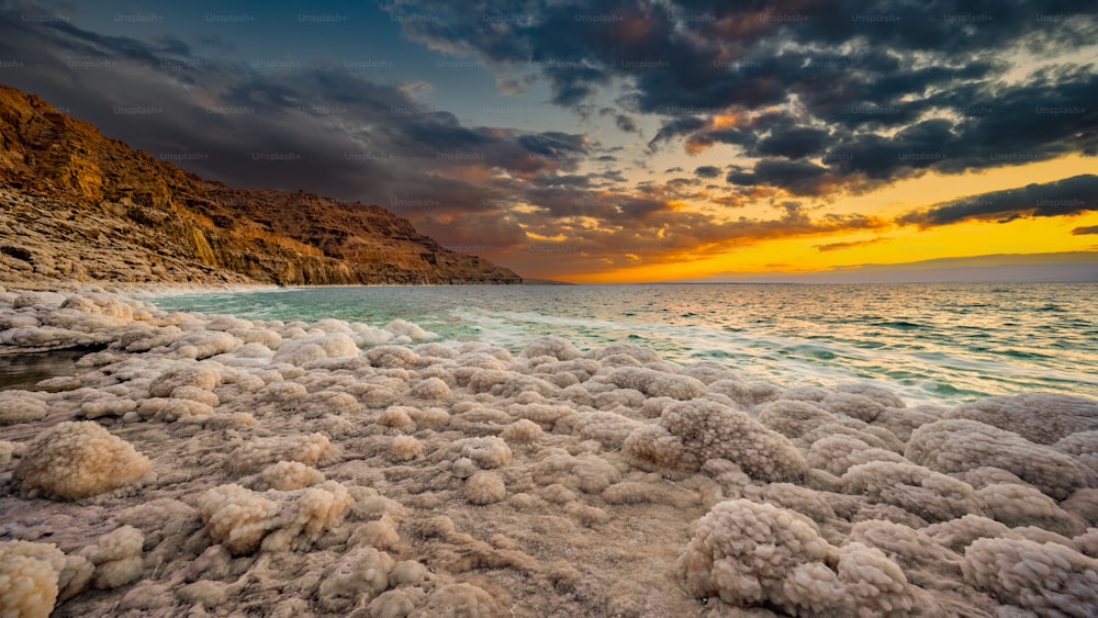 Sunset over salt formations on the shore of the Dead Sea in Jordan.