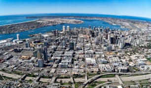 An aerial shot of the cityscape of downtown San Diego, California, surrounded by the ocean