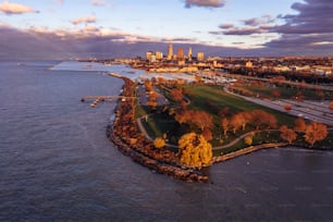 An aerial view of downtown Cleveland at sunset with the docks at Edgewater Park in front