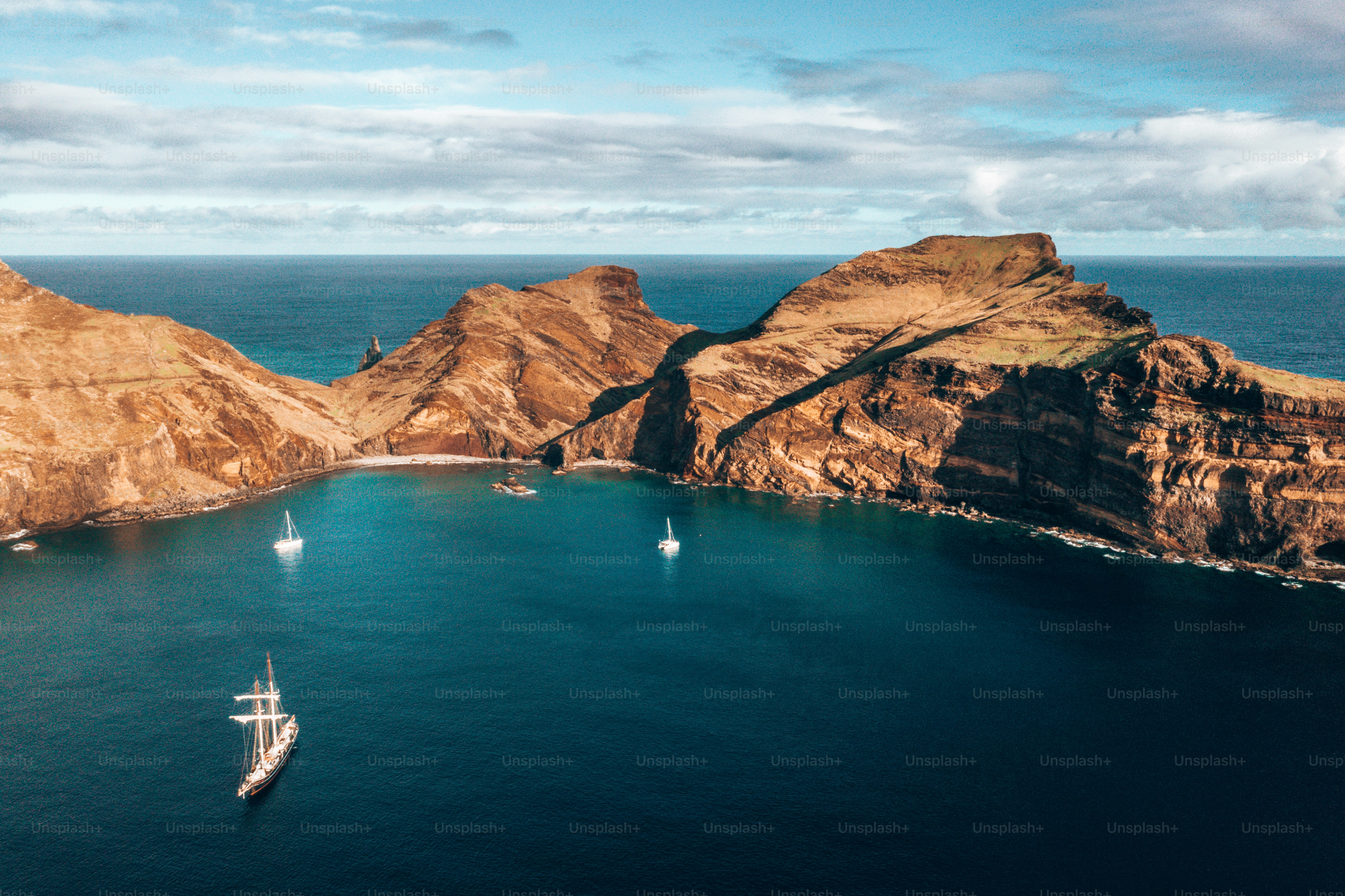 A fascinating aerial view of wild beach and cliffs at Ponta de Sao Lourenco under the blue sky