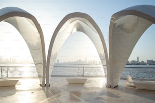 Dubai Creek Harbour arches at sunset with city and Khalifa at the back