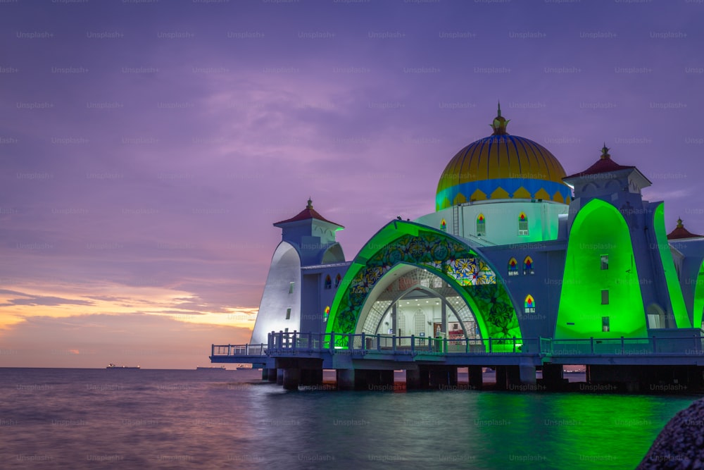 A scenic view of Melaka Straits Mosque in Malaysia on bright sunset sky background