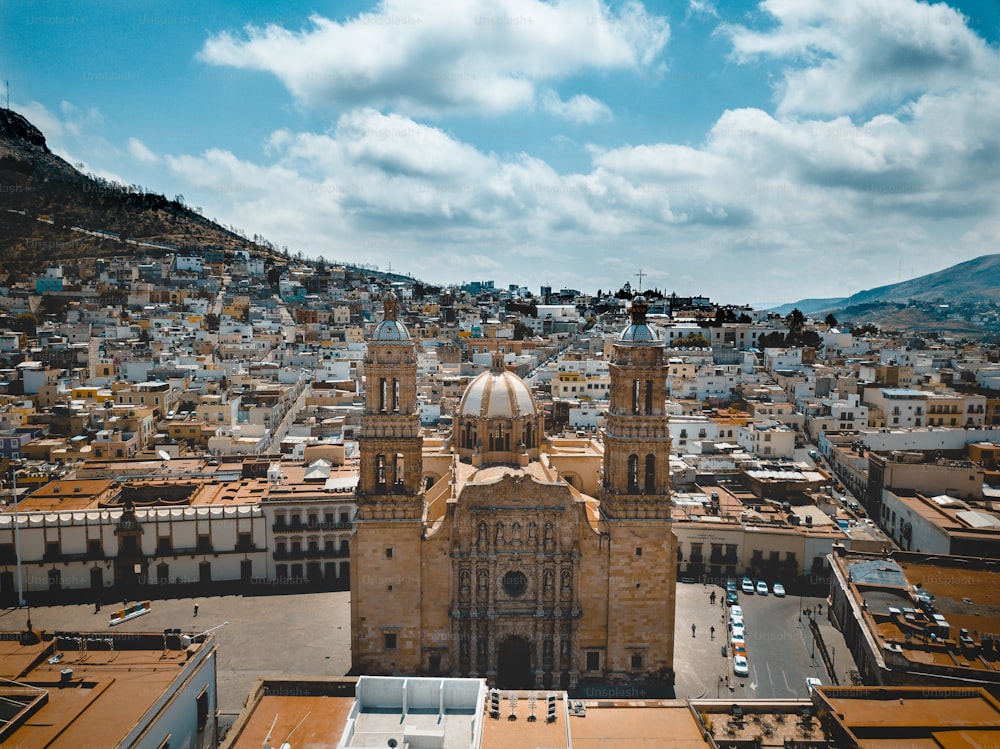 An aerial shot of the cathedral in Zacatecas Mexico under a blue cloudy sky