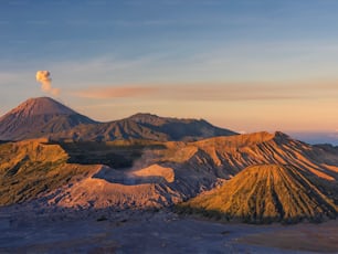 An aerial view of Bromo Mountain peak during pastel orange and blue sunset in Indonesia