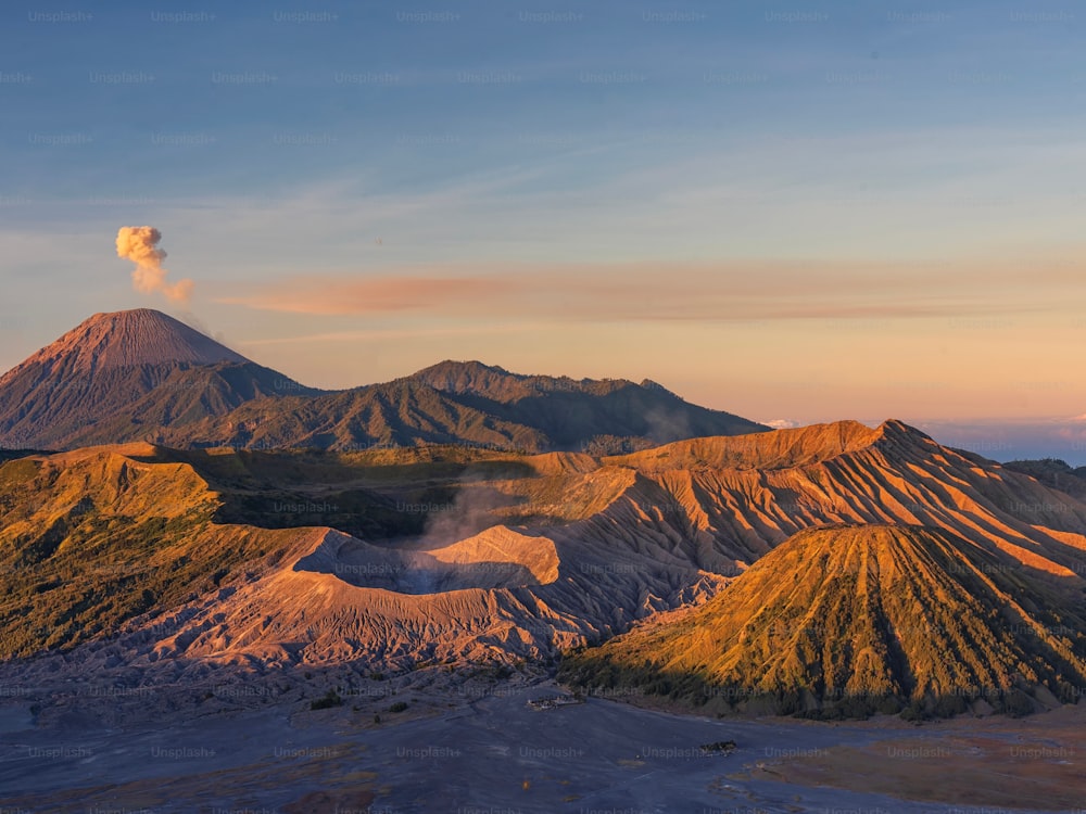 An aerial view of Bromo Mountain peak during pastel orange and blue sunset in Indonesia