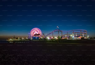 The illuminated roller coaster in Santa Monica, CA at night