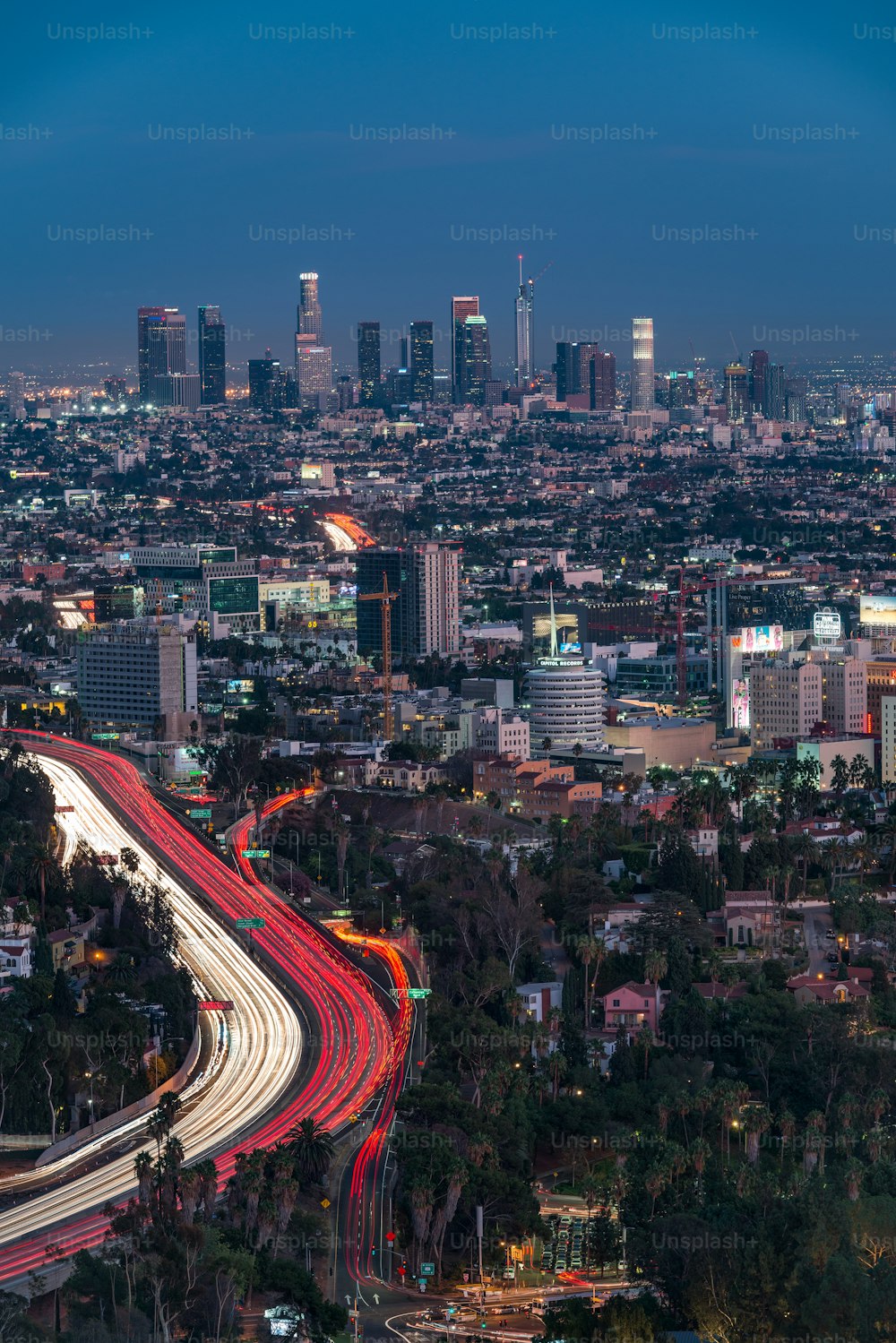 A vertical high angle shot of the illuminated Los Angeles, CA at night