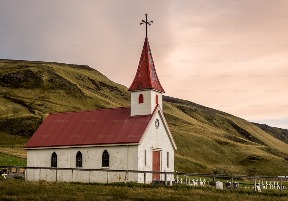 Unique little white church with a red roof Reyniskyrka in Vik Iceland