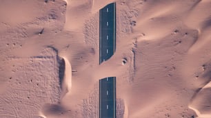 An aerial top view of roads through sand dunes in Dubai, UAE