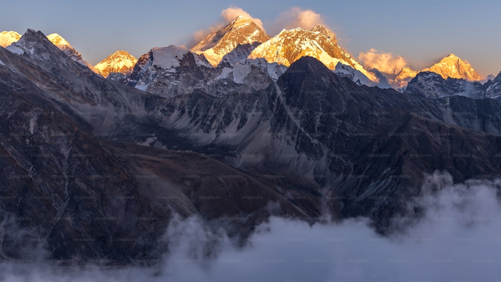 A breathtaking shot of Everest mountain covered in snow from Gokyo Ri, Nepal. Perfect for a wallpaper or a background.