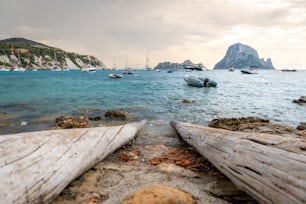 A view of the sea with boats in Es Vedra from a boat channel