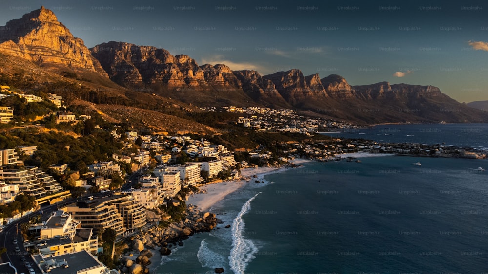 An aerial view of the coastal city and Clifton Beach in Cape Town, South Africa during sunset