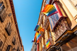 The balconies of the Chueca neighborhood of Madrid adorned with the colors of the lgbt rainbow flag