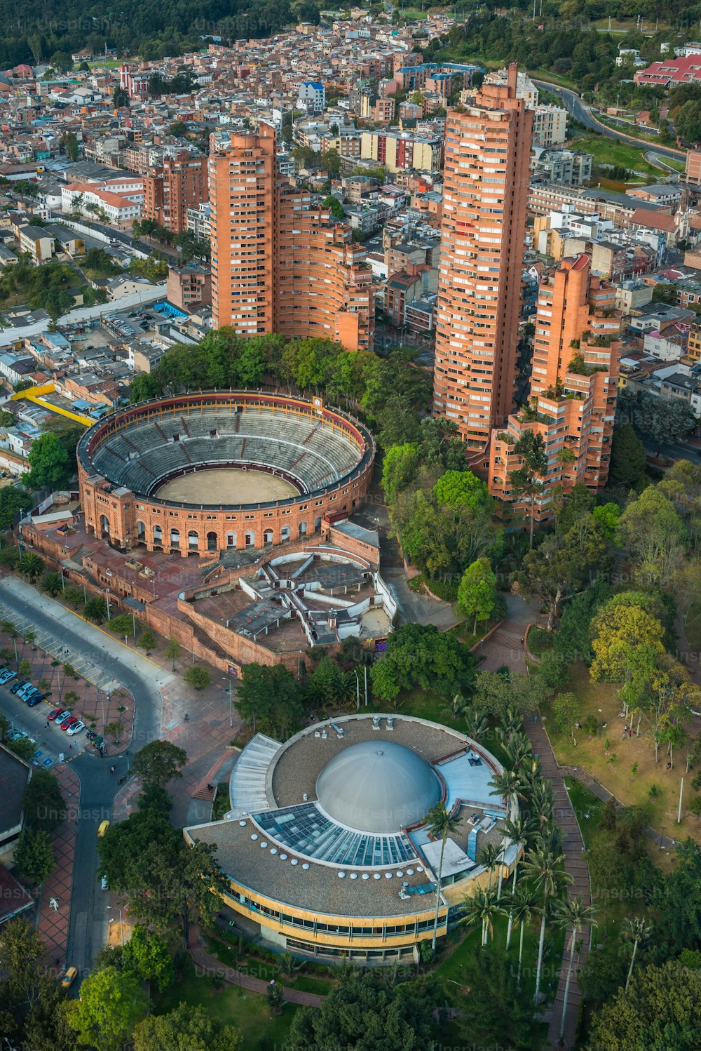 A vertical aerial view of the famous Santamaria Bullfighting arena and the surrounding buildings in Bogota, Colombia