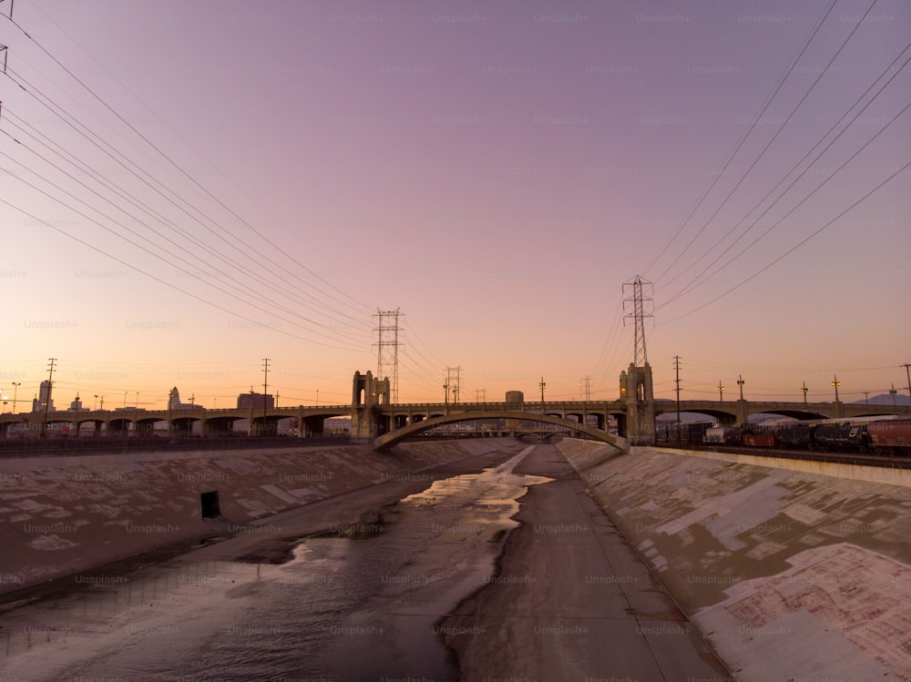 A Beautiful view of LA river with 6th street bridge against sunset