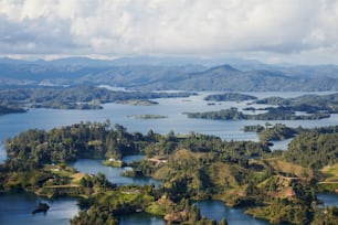 An aerial shot of the Guatape town in Columbia with mountains and clouded sky in the background