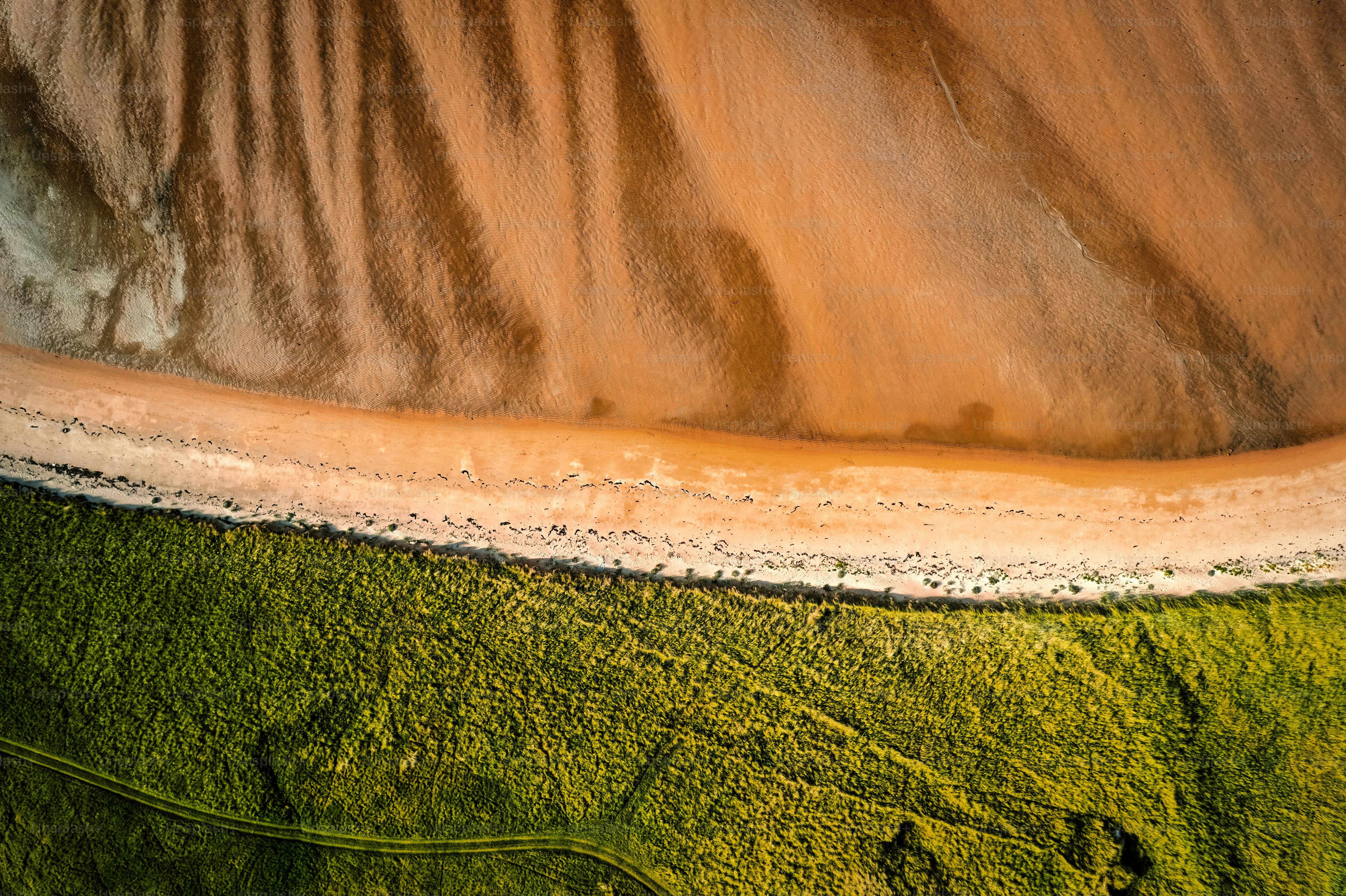 An aerial top view of the sandy shore in Donegal Ireland on a sunny day