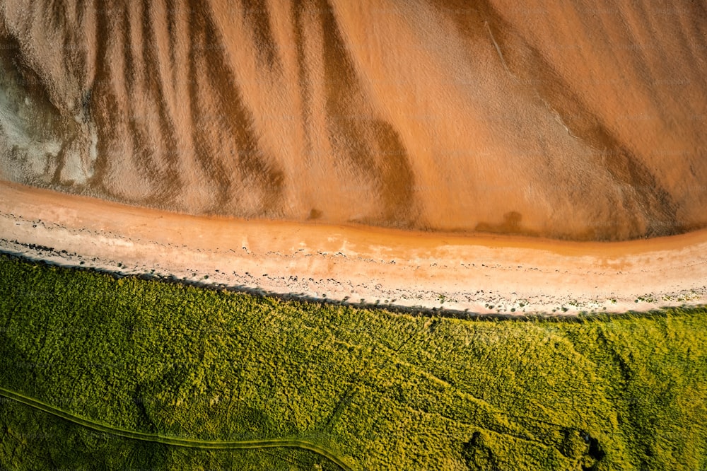 An aerial top view of the sandy shore in Donegal Ireland on a sunny day