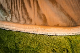 An aerial top view of the sandy shore in Donegal Ireland on a sunny day