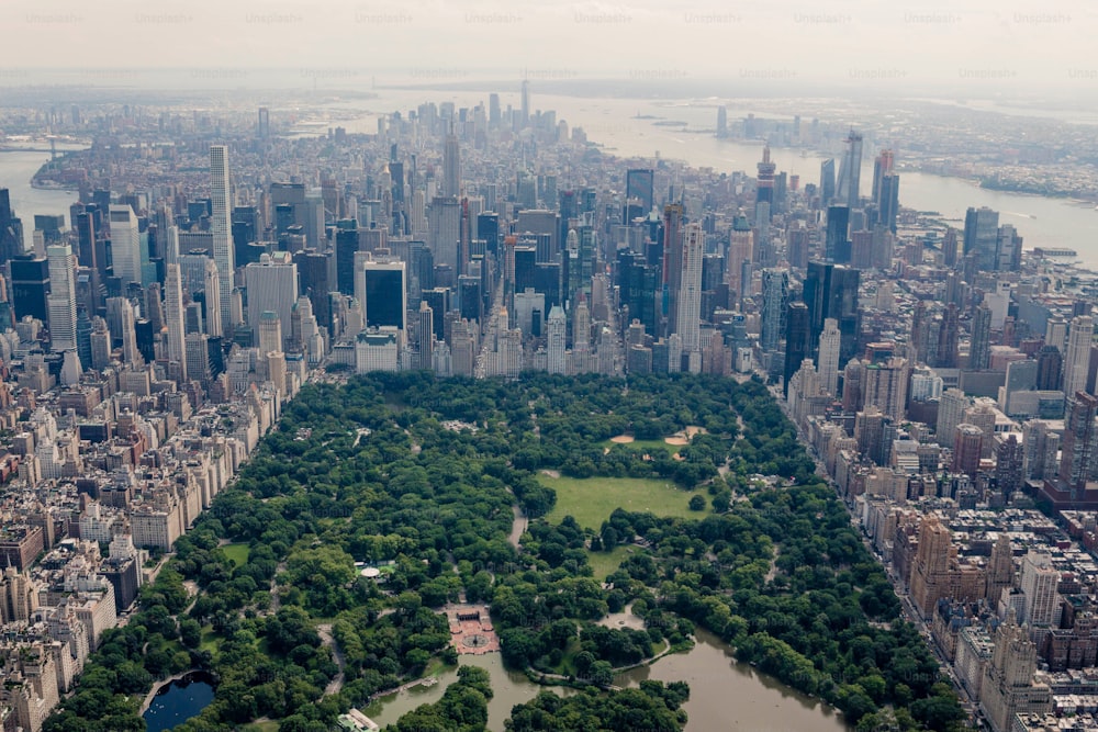An aerial shot of the Central Park of New York city surrounded by urban skyscrapers