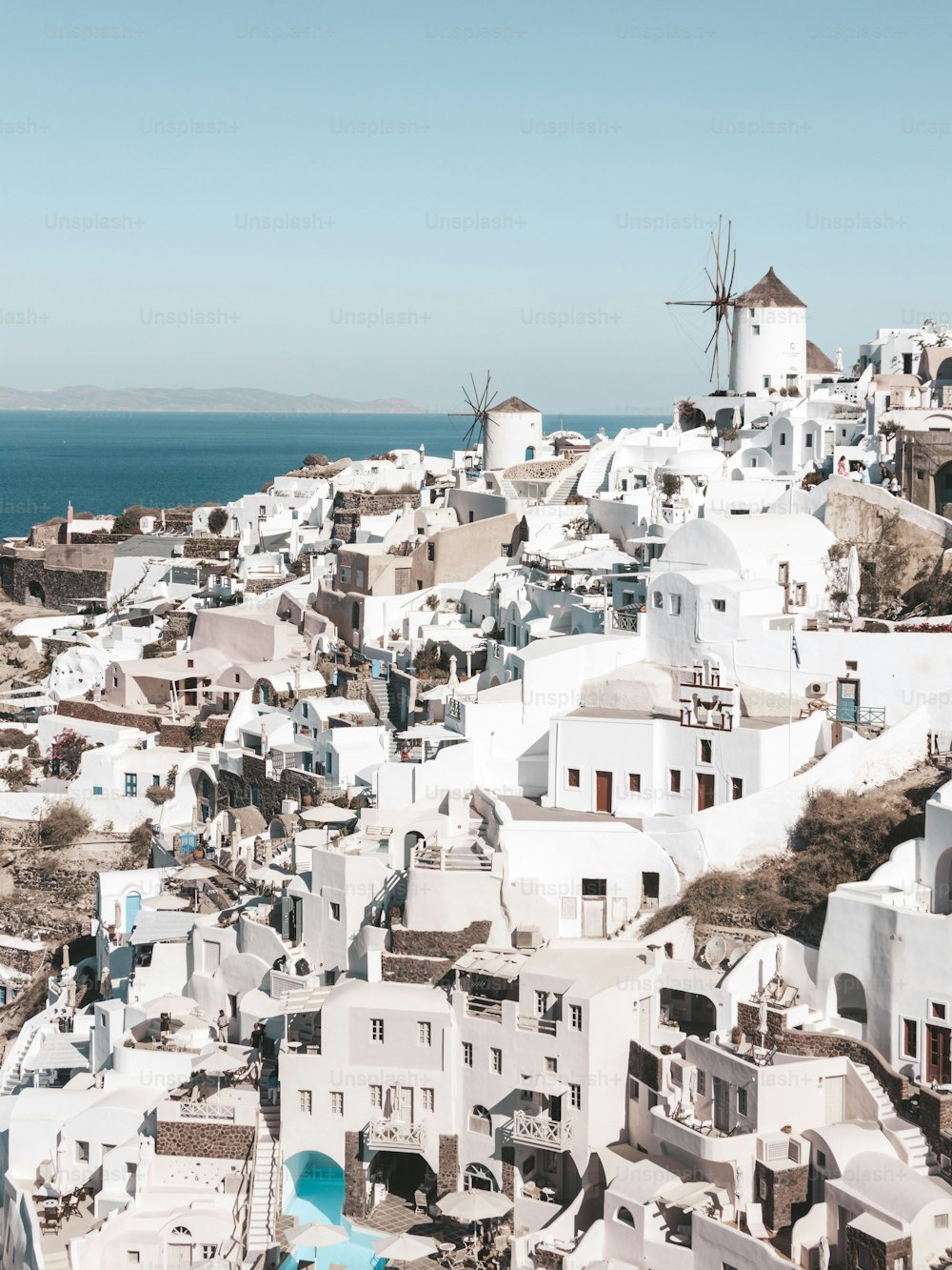 The beautiful cityscape of the white buildings of Santorini under the clear blue sky in Greece