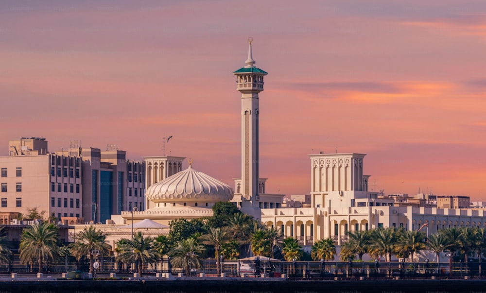 A mosque near the Dubai canal with a scenic sunset skyscape in the background