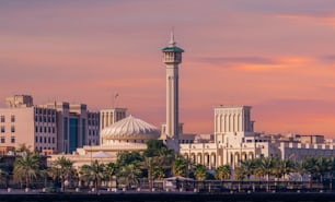 A mosque near the Dubai canal with a scenic sunset skyscape in the background