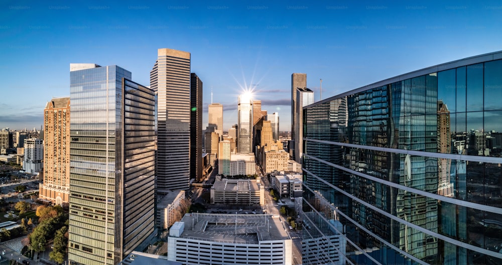 an aerial view of a city skyline in the late afternoon