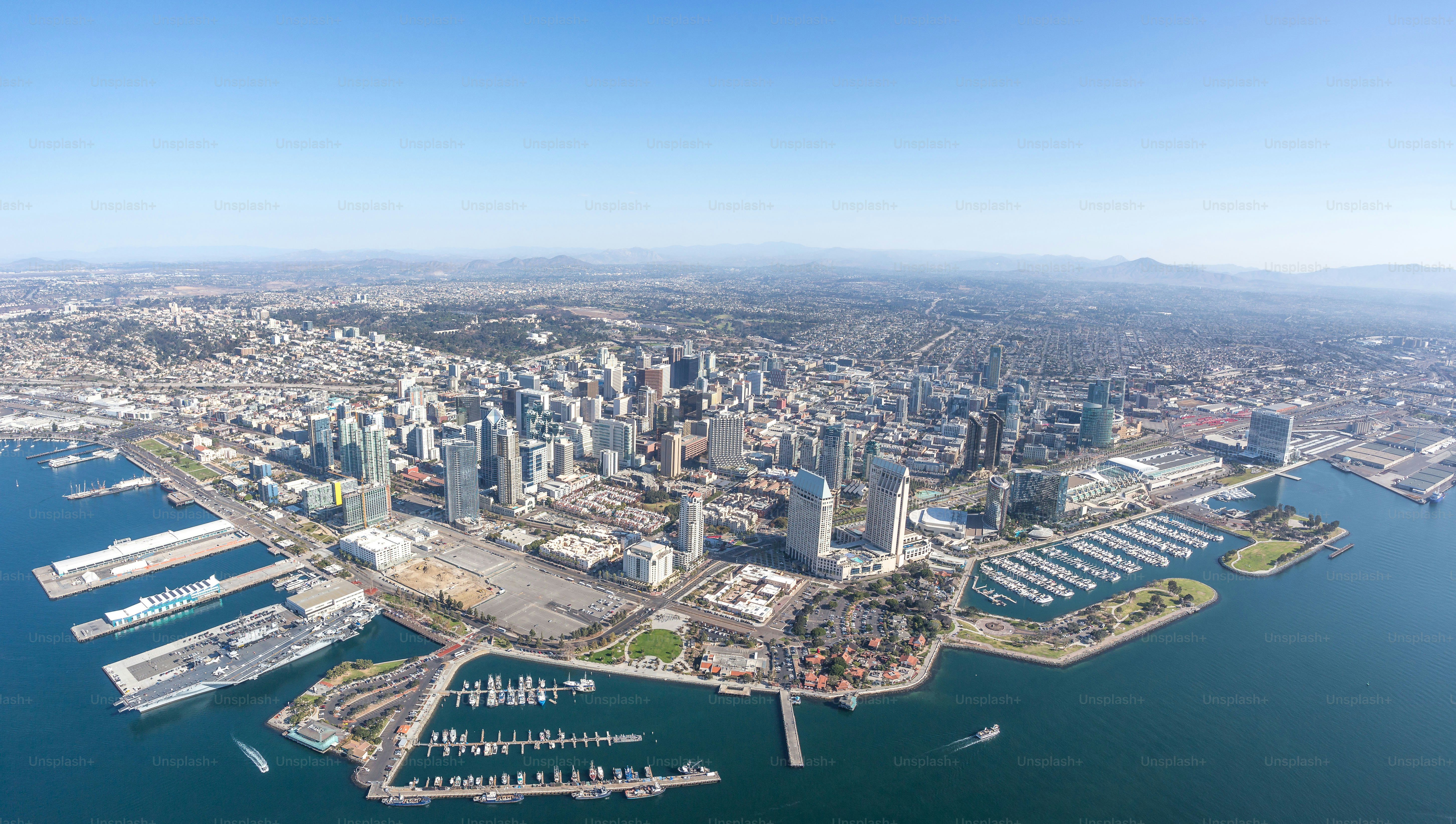 An aerial shot of the cityscape of downtown San Diego, California, surrounded by the ocean