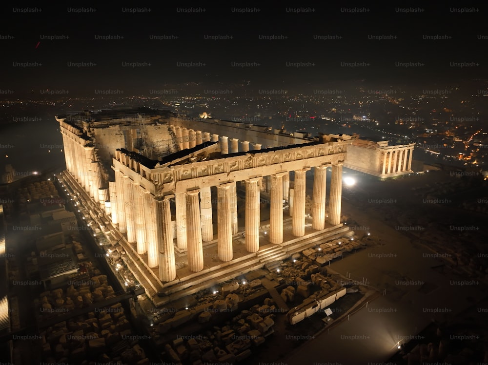 An aerial shot of the Parthenon temple at night in Athens, Greece.