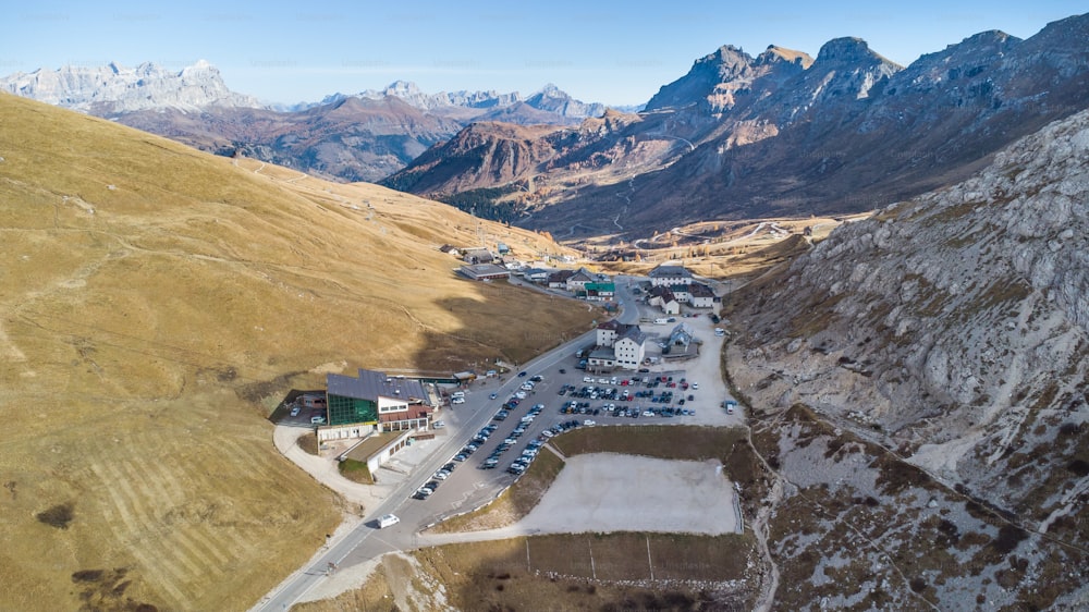 Aerial view of Passo Pordoi mountain pass road in the italian Dolomites near Cortina d'Ampezzo during autumn