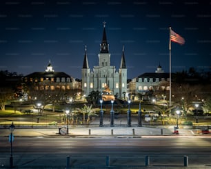 A night shot of buildings and the Flag of the USA in New Orleans