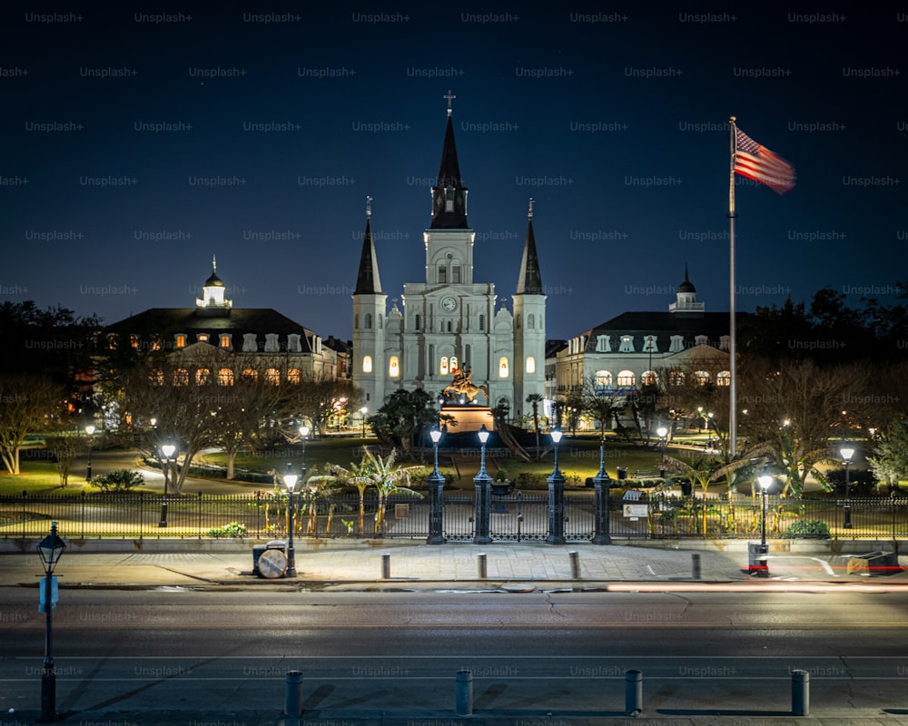A night shot of buildings and the Flag of the USA in New Orleans