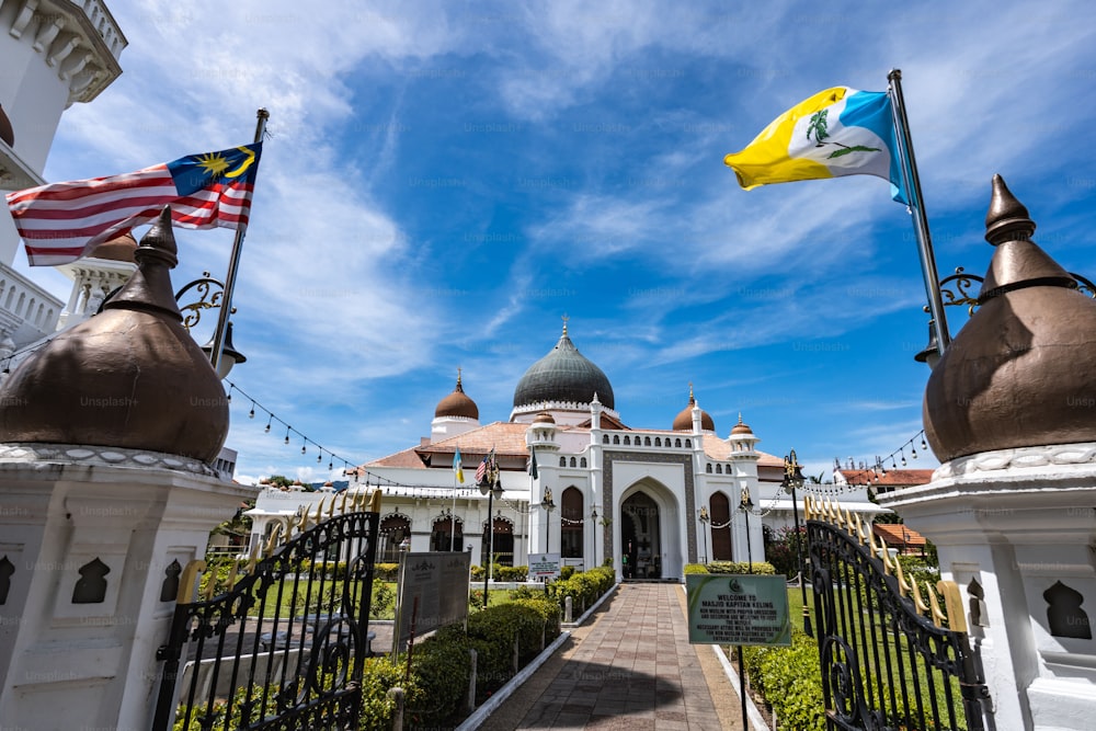 Die Masjid Kapitan Keling älteste Moschee in Georgetown, Penang, Malaysia mit Flaggen im Weitwinkel und Eingangsfront