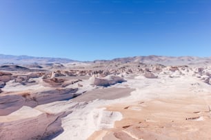 A stunning barren area in a white desert with volcanic rock formations in Campo De Piedra Pomez
