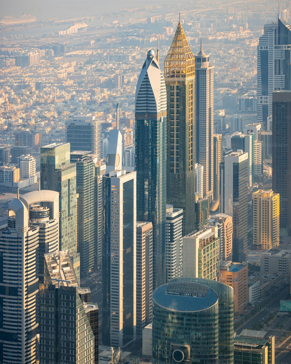 An aerial shot of bustling modern cityscape featuring multiple tall skyscrapers in Dubai, UAE.