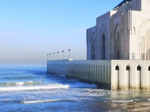 The exterior of Hassan II Mosque by the sea with blue sky in Casablanca, Morocco