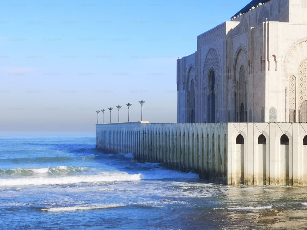 The exterior of Hassan II Mosque by the sea with blue sky in Casablanca, Morocco