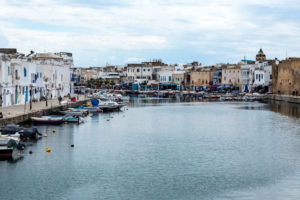 This stock photo shows a tranquil port in Bizerte, Tunisia, with a boat peacefully bobbing in the sea